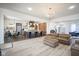 Bright, open-concept living area with hardwood floors, modern lighting, and seamless kitchen access at 13947 Morningtide Cir, Fishers, IN 46038