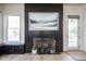 Stylish living room showcases a modern fireplace and a door leading to the backyard at 13947 Morningtide Cir, Fishers, IN 46038