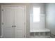 Well-lit mud room with storage bench, coat hooks, and built in shoe storage space at 13947 Morningtide Cir, Fishers, IN 46038
