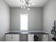 Well-lit office features built in cabinet and counter space with a large window overlooking the yard at 13947 Morningtide Cir, Fishers, IN 46038