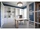 Bright home office with custom built-ins, desk, and chair offers an ideal workspace at 13947 Morningtide Cir, Fishers, IN 46038