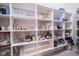 Spacious pantry with custom shelving for ample storage and organization possibilities at 13947 Morningtide Cir, Fishers, IN 46038