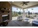 Relaxing outdoor space with a brick fireplace, comfortable seating, and a dining area, perfect for entertaining at 13947 Morningtide Cir, Fishers, IN 46038