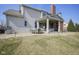 Rear exterior view of the home with a patio that offers a barbecue grill, table, and seating at 13947 Morningtide Cir, Fishers, IN 46038