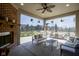 Covered patio features a fireplace, comfy seating, and outdoor dining with views of the backyard at 13947 Morningtide Cir, Fishers, IN 46038