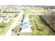 Aerial view of a neighborhood with homes, green spaces, and trees offering serene environment at 1405 Creekside Dr, Brownsburg, IN 46112