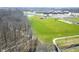 Aerial view features greenery and a wooded area near the property with a pond at 1405 Creekside Dr, Brownsburg, IN 46112