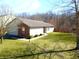 Well-maintained single-story home featuring a brick accent, manicured lawn, and mature trees surrounding the property at 1405 Creekside Dr, Brownsburg, IN 46112