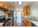 Well-lit kitchen with wood cabinets, stainless steel appliances, and an open layout, connecting to the dining area at 1405 Creekside Dr, Brownsburg, IN 46112