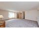 Open living room with carpet, a front door with sidelights, and a lamp on a side table, creating a welcoming space at 1405 Creekside Dr, Brownsburg, IN 46112