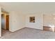 Bright living room area, leading into a dining space with wood floors, and a glimpse of the kitchen through the opening at 1405 Creekside Dr, Brownsburg, IN 46112