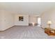 Spacious living room featuring neutral walls and carpet, connected to the dining area with wood flooring at 1405 Creekside Dr, Brownsburg, IN 46112