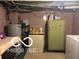 Unfinished basement featuring plumbing and vintage storage appliances at 1405 N Mount St, Indianapolis, IN 46222