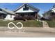 Inviting single-story home with a cozy covered porch and easy access via sidewalk and short steps at 1405 N Mount St, Indianapolis, IN 46222