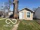 Exterior view of shed providing extra storage space alongside a mature tree at 1405 N Mount St, Indianapolis, IN 46222