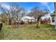 Manicured backyard with a deck, mature trees, patio, pergola, and lush green grass at 15192 Porchester Dr, Noblesville, IN 46062