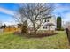 Manicured backyard with a deck, mature trees, patio, pergola and lush green grass at 15192 Porchester Dr, Noblesville, IN 46062