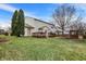 Manicured backyard with a deck, mature trees, patio and lush green grass at 15192 Porchester Dr, Noblesville, IN 46062