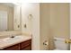 Bathroom featuring a vanity with a mirror, toilet, and beige walls at 15192 Porchester Dr, Noblesville, IN 46062