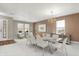 Bright dining room featuring neutral walls, a modern chandelier, and seating for eight, perfect for entertaining at 15192 Porchester Dr, Noblesville, IN 46062
