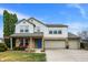 Charming two-story home showcasing a well-manicured front yard, brick accents, and a welcoming blue front door at 15192 Porchester Dr, Noblesville, IN 46062