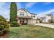 Beautifully landscaped front yard featuring a lush lawn, mature trees, and charming curb appeal for a welcoming feel at 15192 Porchester Dr, Noblesville, IN 46062