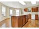 Kitchen island featuring ample storage, a breakfast bar, and a view into the dining area, perfect for entertaining at 15192 Porchester Dr, Noblesville, IN 46062
