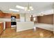 Spacious kitchen featuring wood cabinets, modern appliances, and a breakfast bar leading to a living area at 15192 Porchester Dr, Noblesville, IN 46062