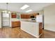 Charming kitchen with wooden cabinets, laminate flooring and modern lighting for a warm, inviting atmosphere at 15192 Porchester Dr, Noblesville, IN 46062