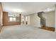 Open concept living room featuring plush carpeting, neutral walls, and easy access to other rooms, perfect for entertaining at 15192 Porchester Dr, Noblesville, IN 46062