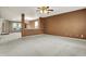 Spacious living room with neutral carpet and brown accent wall, perfect for relaxation and entertaining at 15192 Porchester Dr, Noblesville, IN 46062