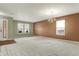 Spacious living room with plush carpeting, neutral walls, and natural light, creating an inviting and versatile space at 15192 Porchester Dr, Noblesville, IN 46062