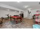 Large open basement recreation area with pool table, treadmill, and staircase at 1521 Avondale Dr, Westfield, IN 46074