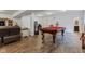 Open finished basement with pool table, arcade game, and tv viewing area at 1521 Avondale Dr, Westfield, IN 46074