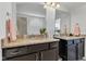 Bathroom boasts double sinks with granite counters and dark cabinets with silver handles at 1521 Avondale Dr, Westfield, IN 46074