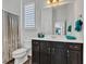 Bright bathroom with a dark wood vanity, ample counter space, and a shower with patterned curtain at 1521 Avondale Dr, Westfield, IN 46074