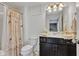Cozy bathroom features vanity, neutral shower curtain with birds, and vanity mirror at 1521 Avondale Dr, Westfield, IN 46074