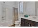 Well-lit bathroom featuring a shower-tub combo and a dark wood vanity with ample counter space at 1521 Avondale Dr, Westfield, IN 46074