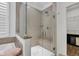 Modern bathroom shower has glass surround and a bench, and tile walls at 1521 Avondale Dr, Westfield, IN 46074
