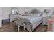 Elegant bedroom with wood flooring, neutral tones, and a decorative upholstered bed frame at 1521 Avondale Dr, Westfield, IN 46074