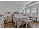Well-lit bedroom with wood floors, shutters, and a decorative headboard at 1521 Avondale Dr, Westfield, IN 46074