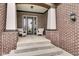 Inviting front porch with brick columns and seating area, creating a welcoming entrance at 1521 Avondale Dr, Westfield, IN 46074