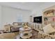 Inviting living room featuring a cozy sofa, patterned armchair, and bright natural light at 1521 Avondale Dr, Westfield, IN 46074
