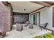 Comfortable patio with brick fireplace, dark wood accents, and relaxing wicker furniture at 1521 Avondale Dr, Westfield, IN 46074