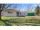 Charming single-story home features a green garage door, a well-maintained lawn, and mature trees at 1620 S East St, Lebanon, IN 46052
