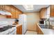 Efficient kitchen with white appliances, wood cabinets, and ample counter space for meal preparation at 1620 S East St, Lebanon, IN 46052