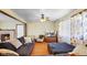 Comfortable living room featuring hardwood floors, a ceiling fan, and a decorative fireplace at 1620 S East St, Lebanon, IN 46052