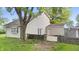 Large backyard with green grass, patio with fence, and plenty of shade trees around house at 1641 Whistler Terrace, Indianapolis, IN 46229
