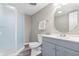 Bathroom with a glass shower, white toilet, and grey vanity at 1641 Whistler Terrace, Indianapolis, IN 46229