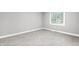 A modest, neutral bedroom with plush carpeting and a bright window at 1641 Whistler Terrace, Indianapolis, IN 46229
